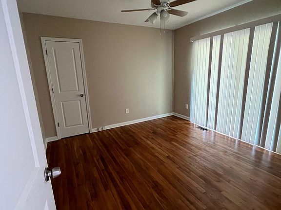 Bedroom 3 or Home Office with slider to terrific concrete patio at rear of home