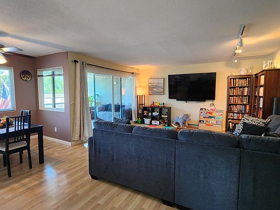Living room with access to the balcony and dining nook.