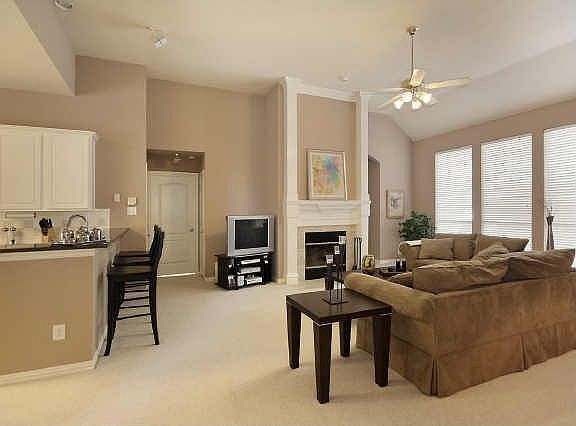 Spacious den features a real wood-burning fireplace and wired surround sound