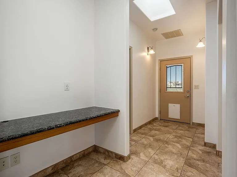 Hallway with skylight and office nook.