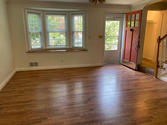 Living room. Front door has been painted white. New ceiling fan installed. Closet to the right.