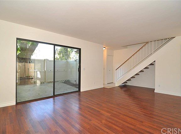 Living Room with patio access & stairs leading to upstairs bedrooms