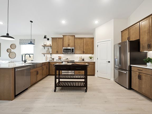 Kitchen with pendant lighting and chrome hardware