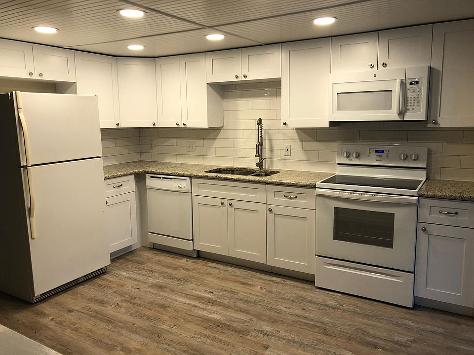Large, new kitchen with many new appliances, granite countertops and tiled back splash .