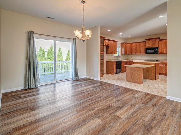 Dining and kitchen area with slider to back deck area. New LVP throughout and updated appliances.