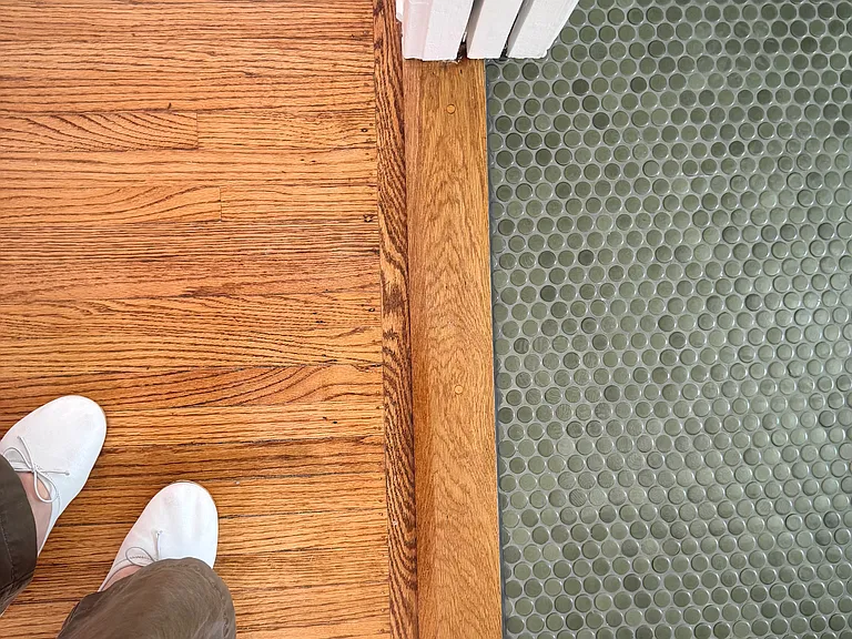 Finishes. Bathroom Hallway. Restored flooring and new tile.