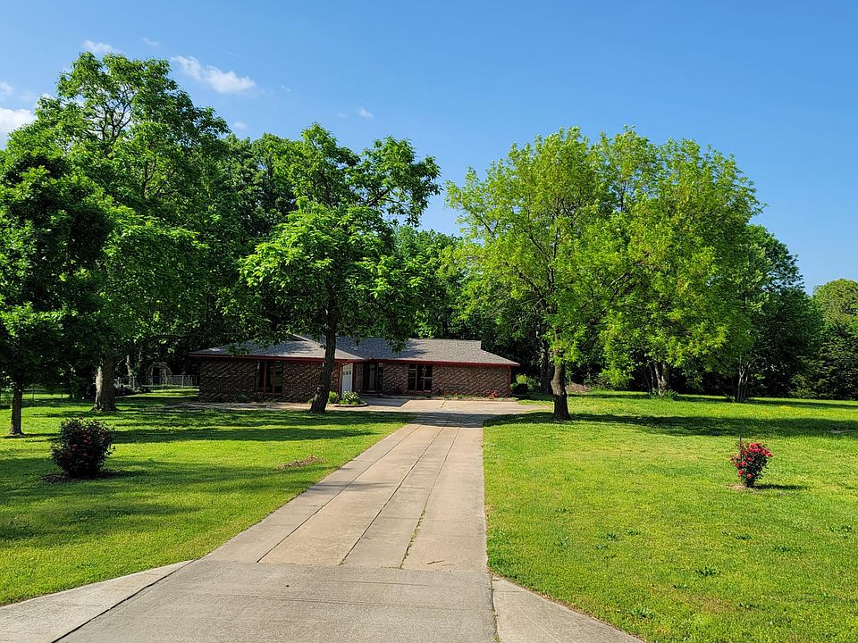 The front of house showing long driveway that puts the house back off the main road
