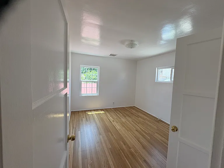 Well-lit second bedroom.