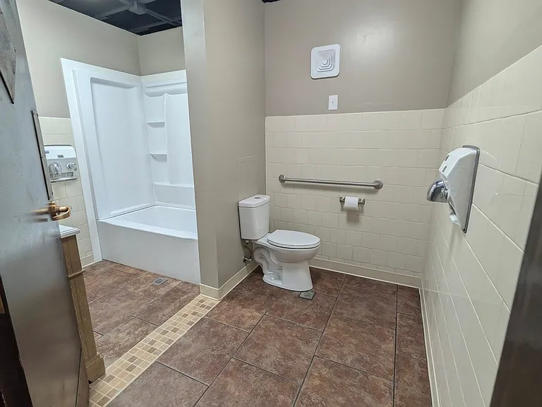 Main bathroom w/grab bar & hand dryers