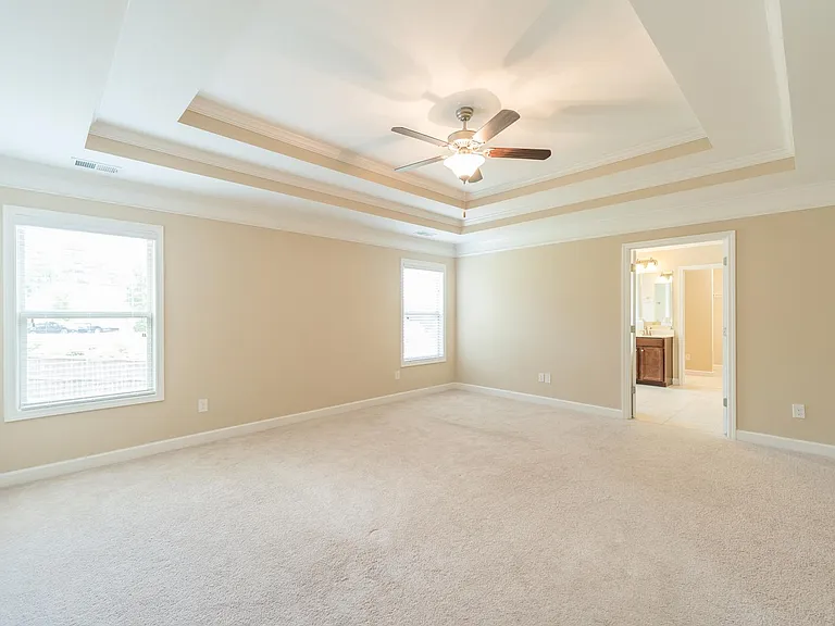 Large Master bedroom with stunning tray ceilings