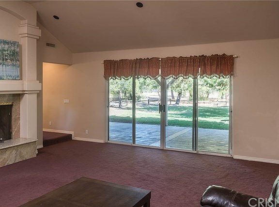 Large living room with dual slider to rear patio