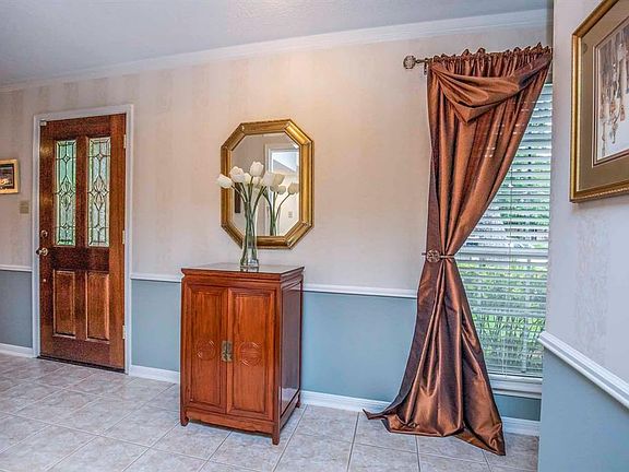 Solid wood & lead glass door greet your guests, along with white moldings & trim that accent the neutral on-trend color pallet.