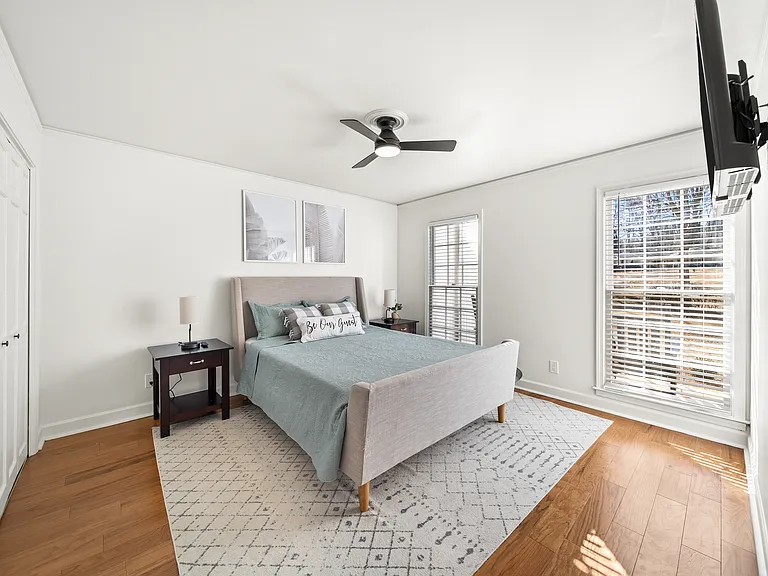 Main Level Bedroom: Enjoy ease and comfort with a main-level bedroom and bathroom_featuring a queen-size bed and Smart Roku TV, perfect for convenient, accessible living all on one floor.