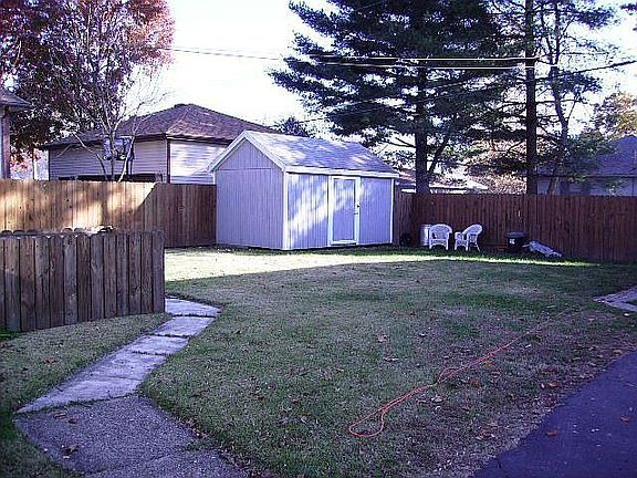 Partially fenced yard with shed