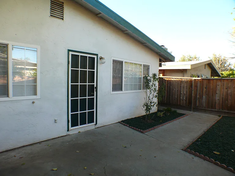 Front door with path through the private yard