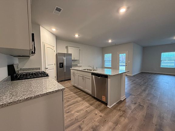 Granite Countertops, Stainless Steal Appliances and overview of breakfast area, living room and covered porch