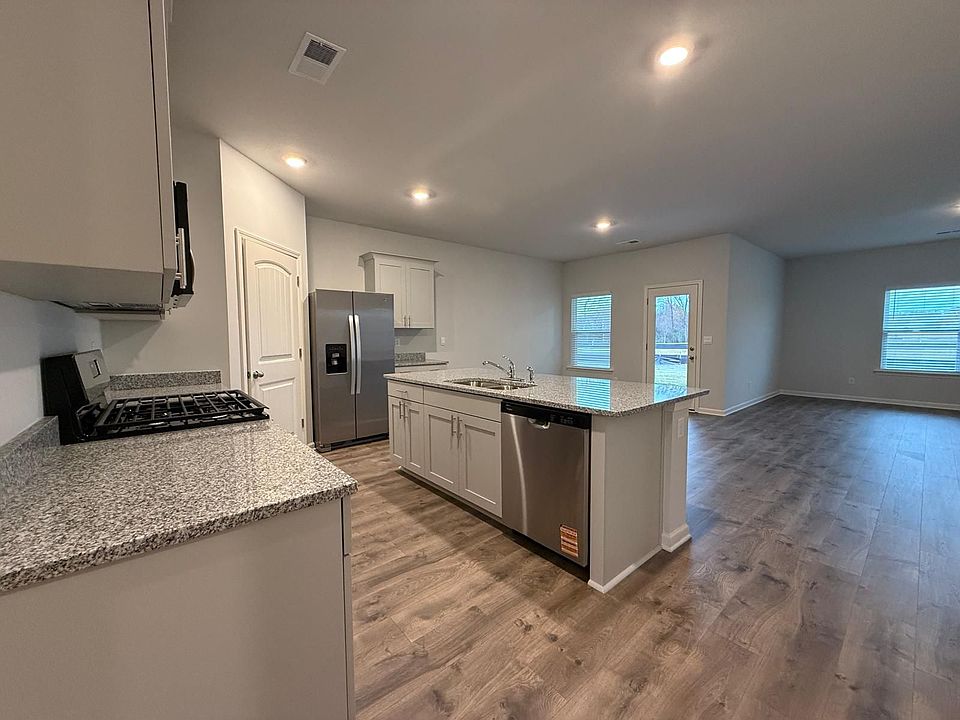 Granite Countertops, Stainless Steal Appliances and overview of breakfast area, living room and covered porch