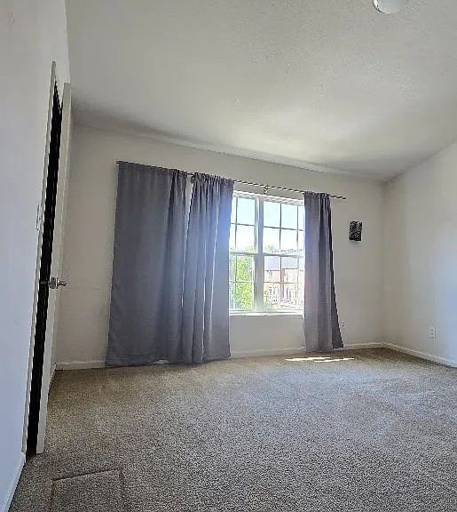 A large window brings in abundant natural light, creating a bright and welcoming atmosphere in the master bedroom.