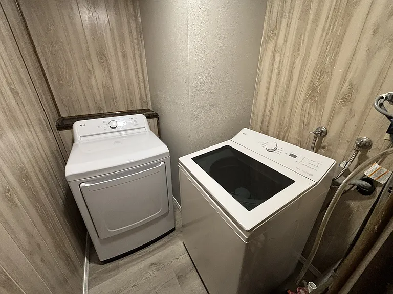 Laundry room with brand new LG smart washer and LG dryer