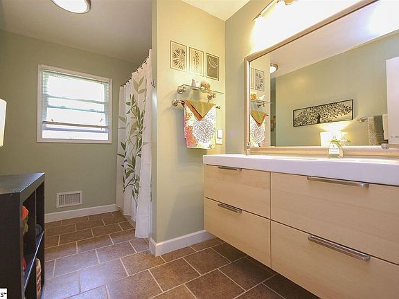 Ceramic tile in the shower, floors, new vanity, new lighting, fresh paint