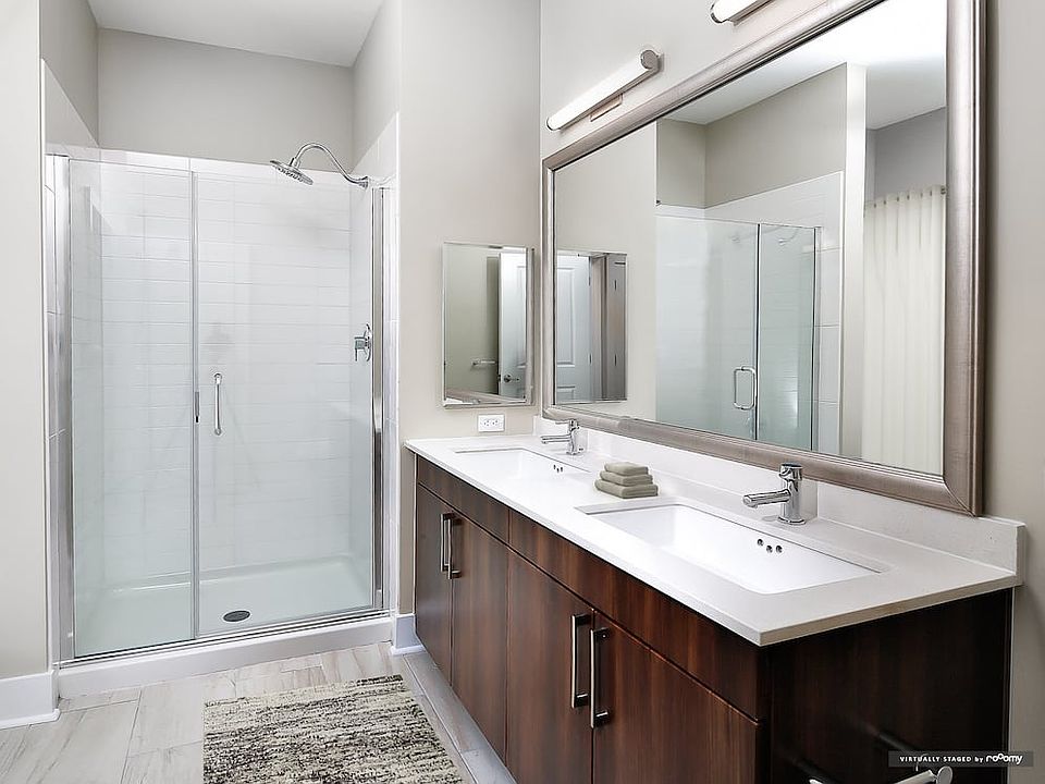 Signature Collection bath with oak cabinetry, white quartz countertops, and hard surface flooring