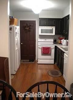 Kitchen : Open floor plan, appliances included, door to garage shown in photo
