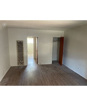 Living room with large storage closet and wall heater