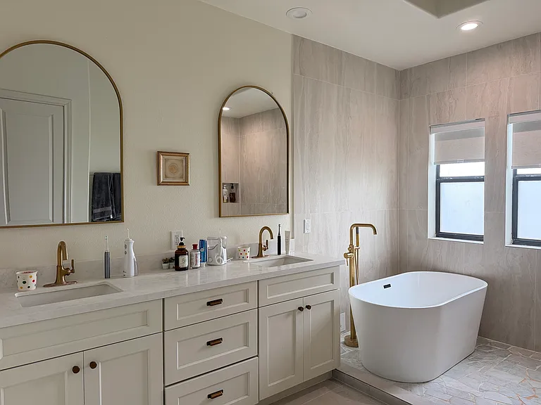 The 3rd-floor master bedroom's renovated bathroom has a new countertop and white cabinet.