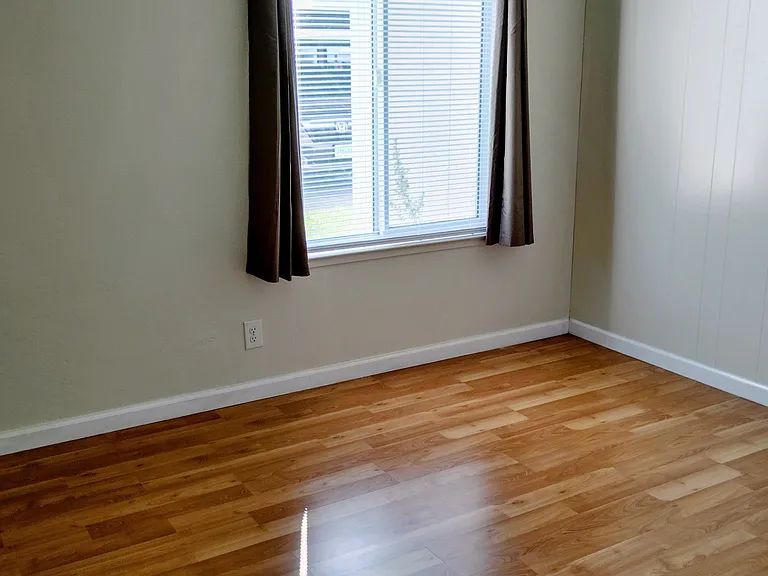 Bedroom includes window coverings and large Walk-in Closet