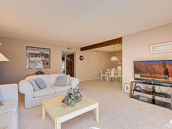 Living room to dining room, with patio access.