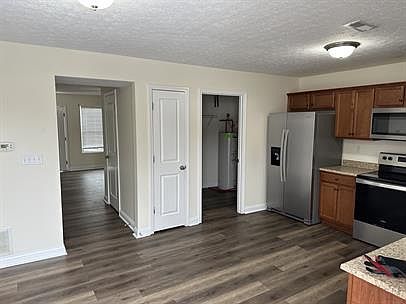 Kitchen, pantry and laundry room with the back exit/patio behind.