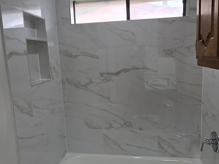 guest bth features window, new tub and tile, new light fixture, new quartz cts