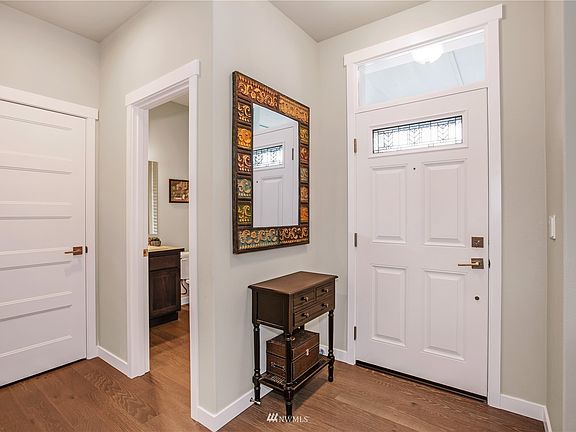 Front entryway with half bath and coat closet.>