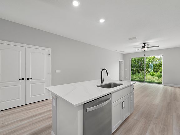 The kitchen island overlooks the dining and family rooms
