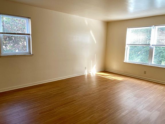 Spacious living room with updated flooring and large windows overlooking the cul-de-sac.