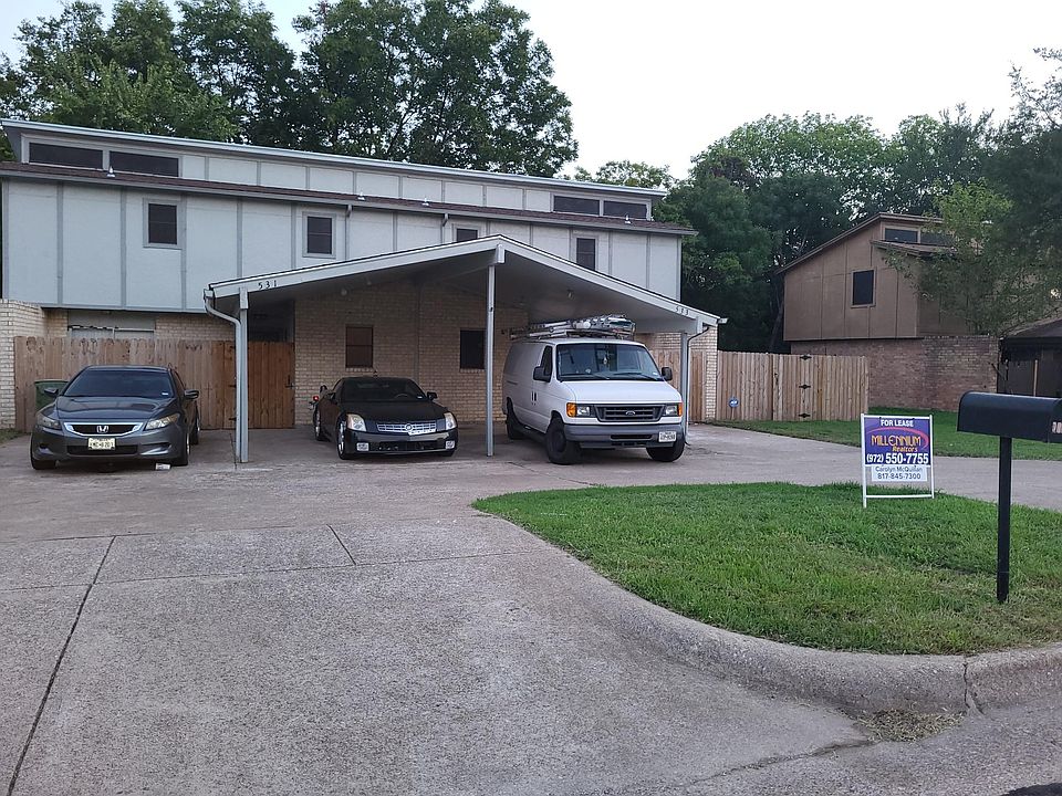 Front view of duplex; 2 carports on right