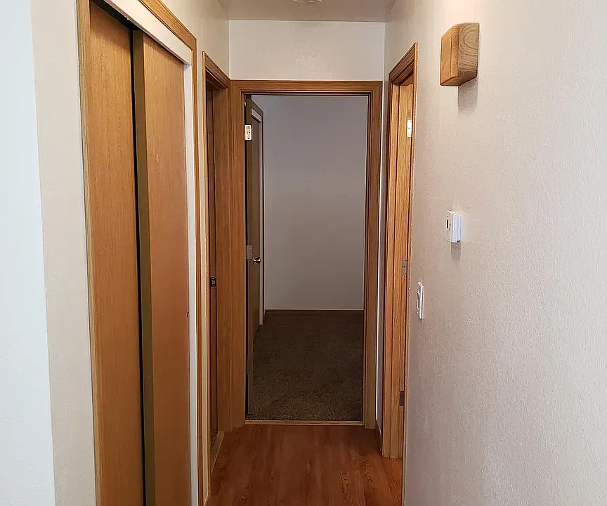 Linen closet located to the left with additional storage space available. Bathroom is to the right. The room for rent is situated at the end of the hall for added privacy.