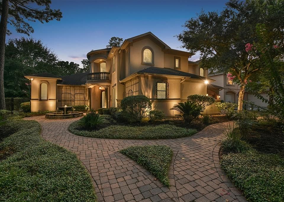 Front of home with exterior lighting