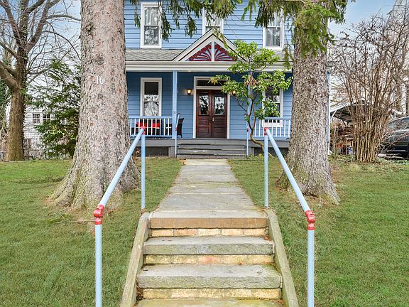Pretty front walk framed by evergreens
