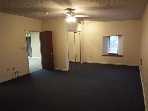 Large master bedroom with walk in closet, ceiling fan and mi