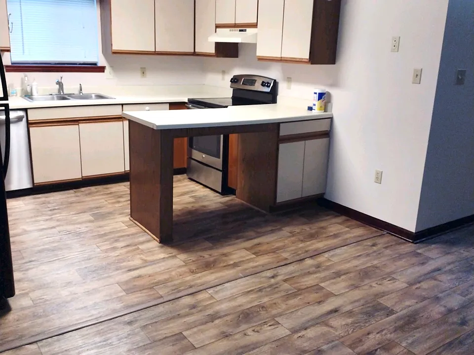 Kitchen with electric stove, window facing sink