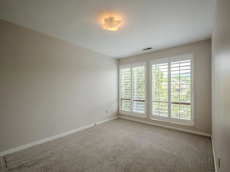 Bedroom 1 with big window and plantation shutters