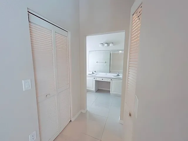 Two Walk in Closets in Master Bedroom and view of Master Bathroom
