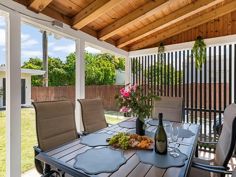 Outdoor dining under the Terrace. The terrace also has the washer and dryer under the enclosure, covered by a privacy fence.