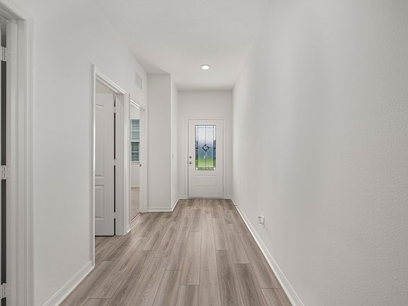 The entryway is highlighted by the gorgeous 3 4 lite front door!
