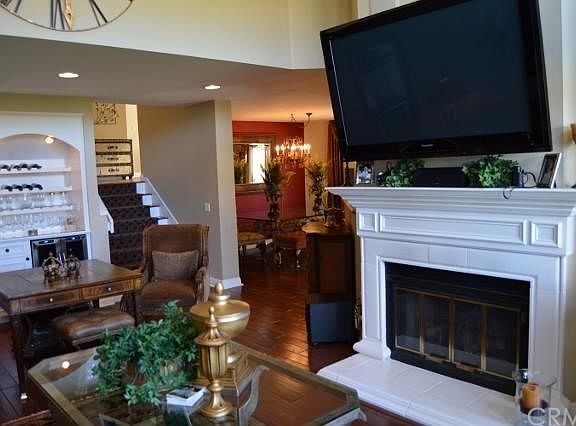 ENTRY FROM FOYER TO LIVING ROOM WITH CUSTOM CABINETRY AND VIEW OF DINING ROOM