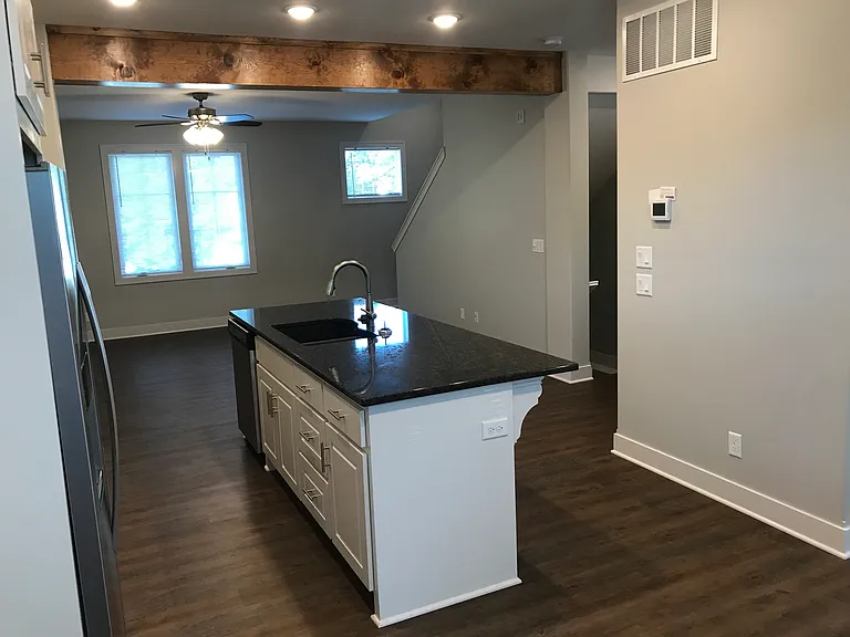From breakfast looking at kitchen in middle and living room beyond