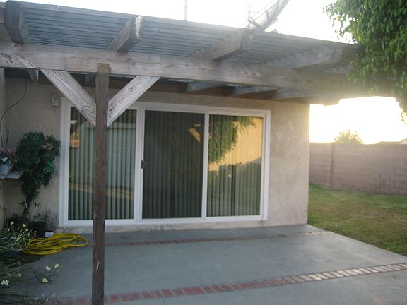 ONE OF TWO PATIOS BEFORE NEW EXTEIOR PAINT