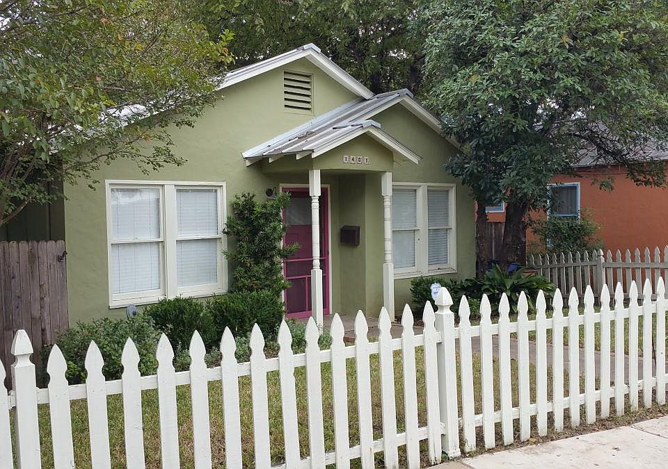 Front view from street. Picket fenced front yard. Stucco ext