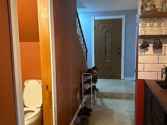 Entrance to the house. Half bath on the left and bar area to the right